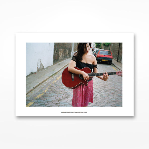Amy Beyond the Stage With A Guitar In Camden Print - A4
