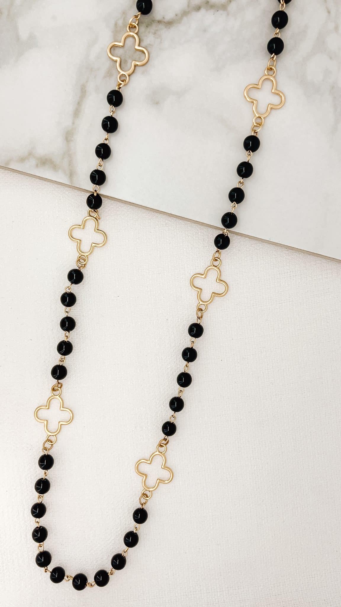 Envy Long Gold And Black Pearl Necklace With Fleur Design