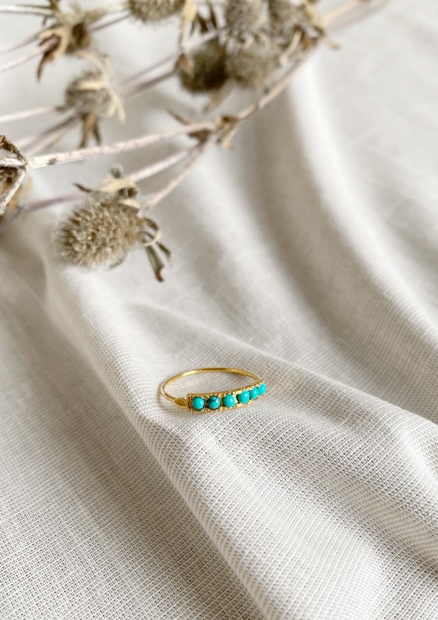 Une A Une Fine gold-plated ring with six turquoise gemstones.